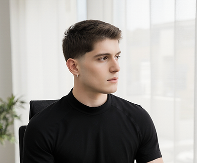 a_young_man_with_fair_skin_short_light_brown_hair_styled_neatly_and_a_lean_build_sitting_a
