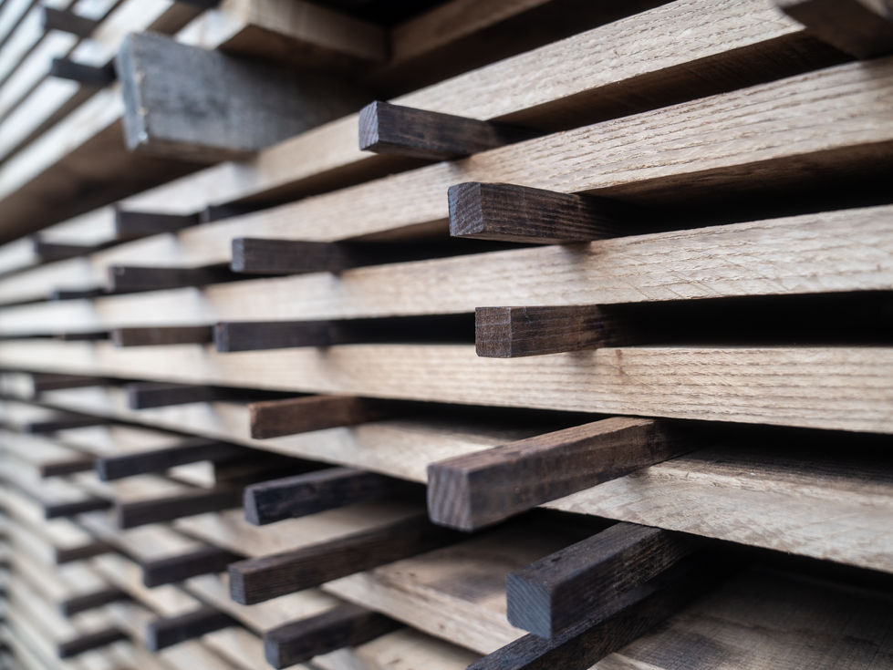 Close up of neatly stacked thermally modified timber with smaller sticks of timber used as spaces for air flow