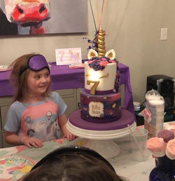Stella Grace with her unicorn cake
