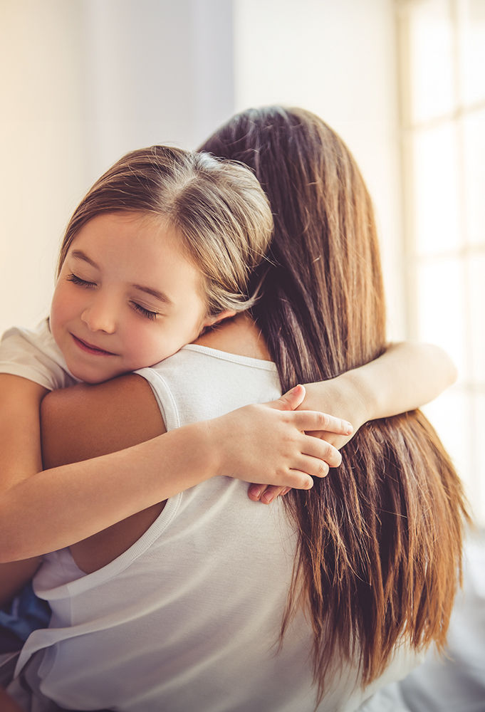 Child being held in mother's arms