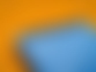 Close-up of a blue September 2022 desk calendar on an orange background, symbolizing the importance of scheduling and managing time effectively for focused 90-minute work sessions.