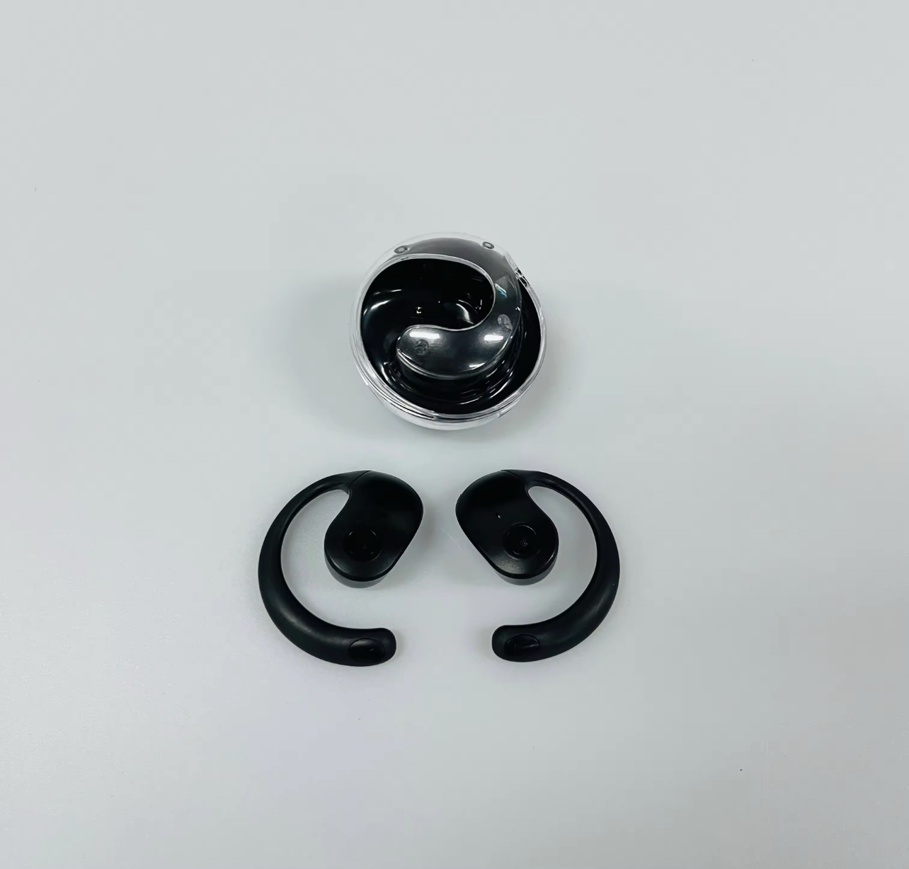 Black AI Translate Earbuds in open charging case on plain background