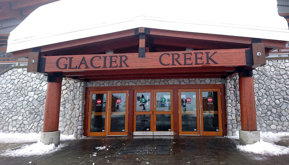 Glacier Creek lodge entrance with snow-covered roof