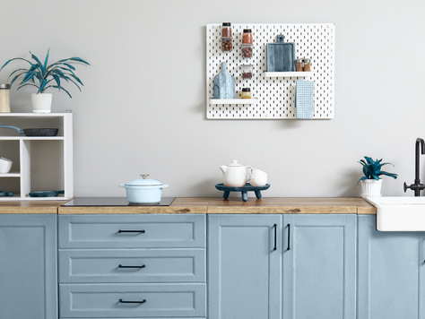 PFAS-free kitchen. Hamptons style, light-filled kitchen with blue cupboards and ceramic pot and accessories