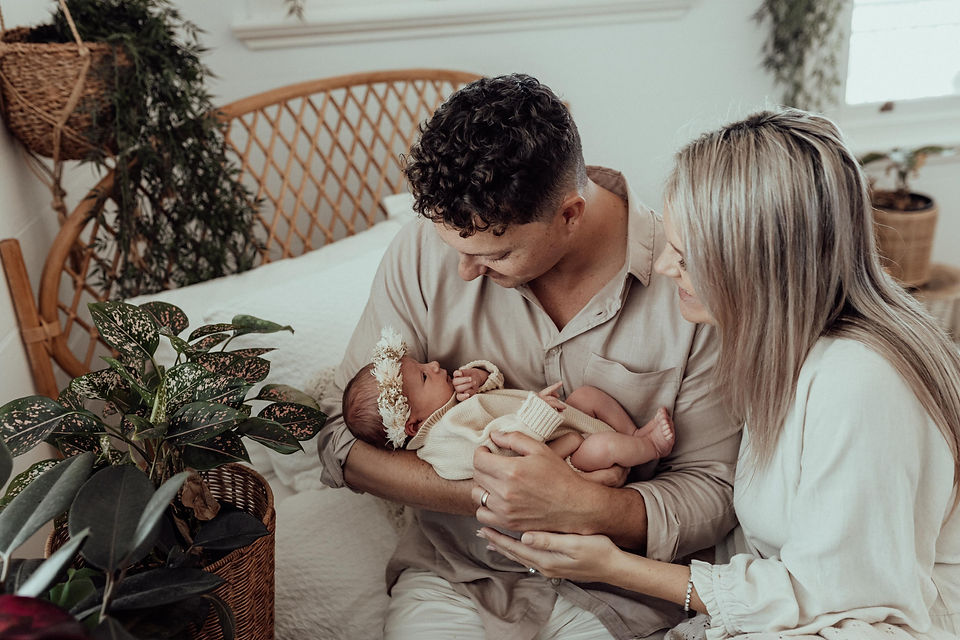 Belly2Birth Hypnobirthing couple holding baby Gigi whilst sitting on a bed