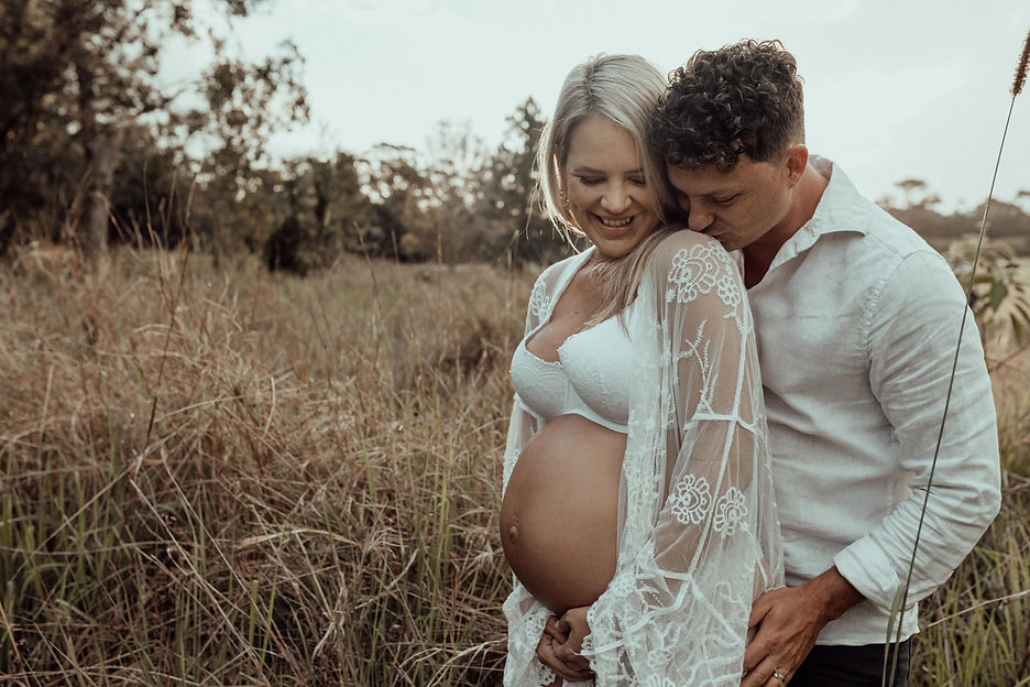 Hypnobirthing clients Ash & Kyle who are the face of Belly2Birth share a loving embrace