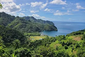 Luxury Bareboat Sailing Yachts and Catamarans anchored near a tropical beach in the Caribbean.
