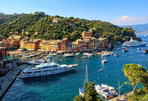 Luxury Sailing yachts and catamarans anchored in the harbor of Portofino, Italy.