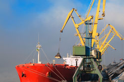 Industrial ship, Portal cranes. Loading coal into the holds of the ship in the seaport
