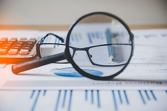 charts-and-graphs-with-magnifying-glass-and-pencil-calculator-clock-reflection-light-and-f