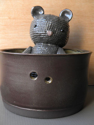 highly textured, large black ceramic cat. Inside a thrown stoneware bowl
