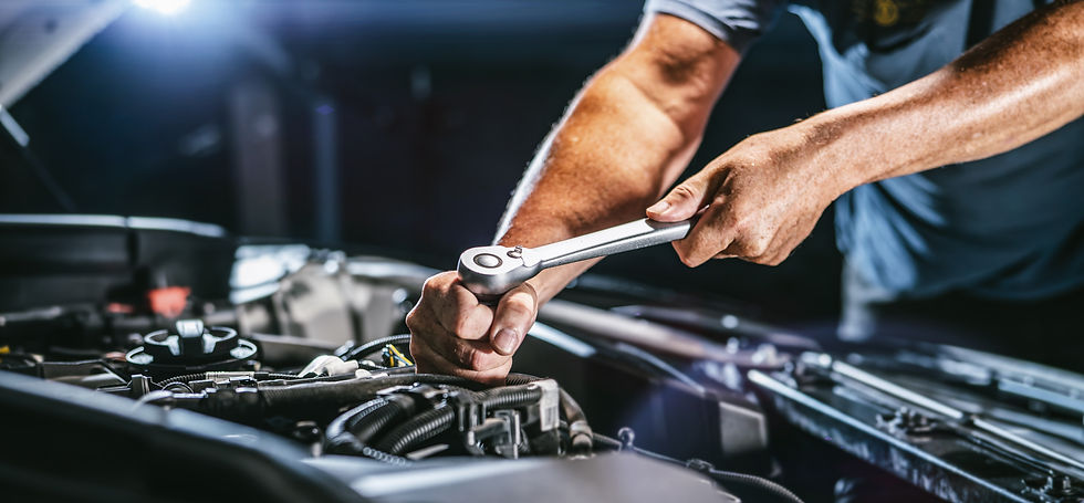 Picture of a mechanic using a socket wrench.