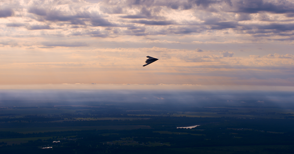 B-2 Spirit seen against the sunset during a USAF training mission.png