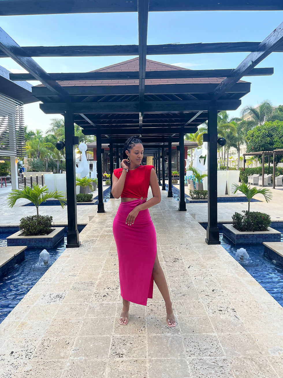Girl in a pink and red dress traveling to a different country