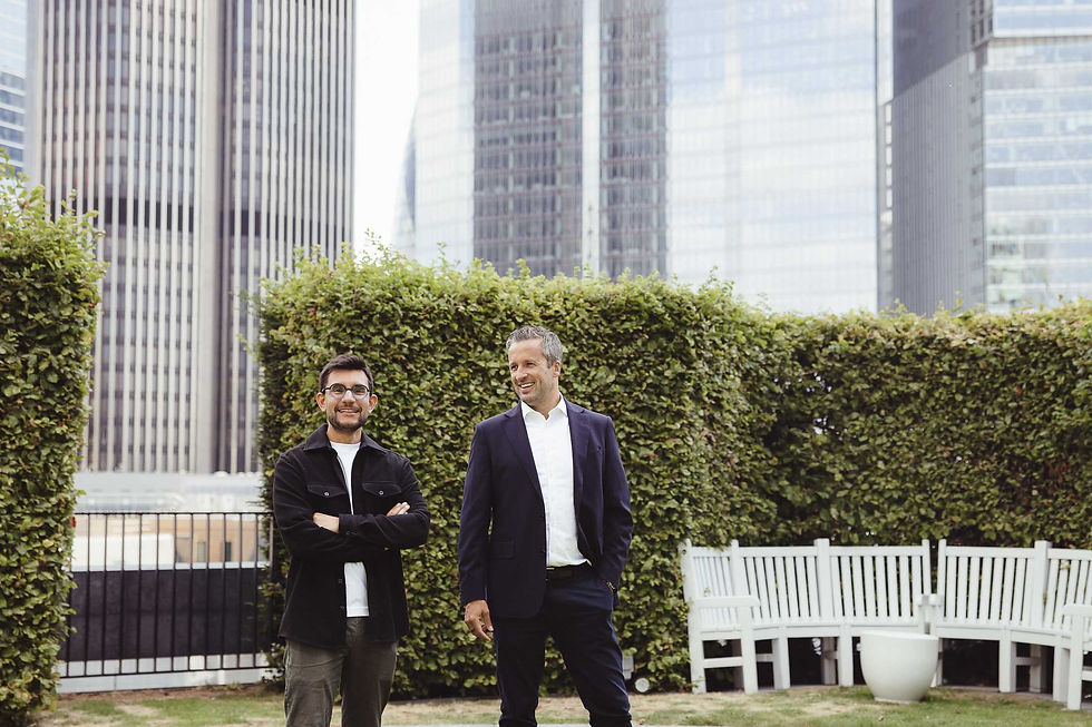Two 7IM colleagues smiling on a City of London rooftop garden, photographed for their corporate team photos
