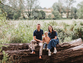 Family wearing coordinating outfits at the park during golden hour.