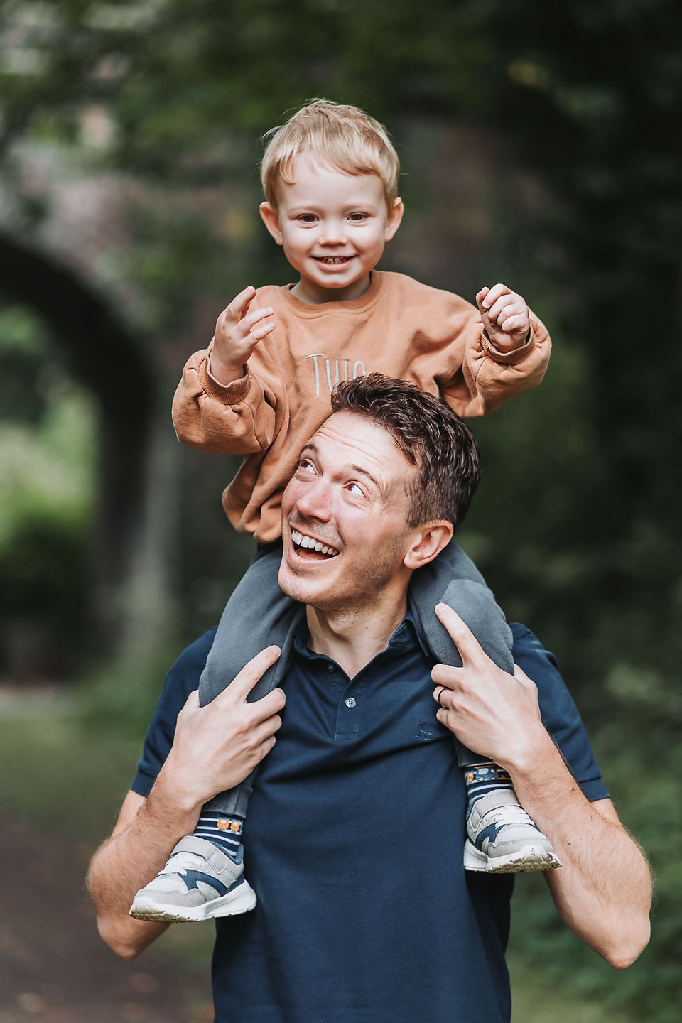 A father and son playing during outdoor family photos.