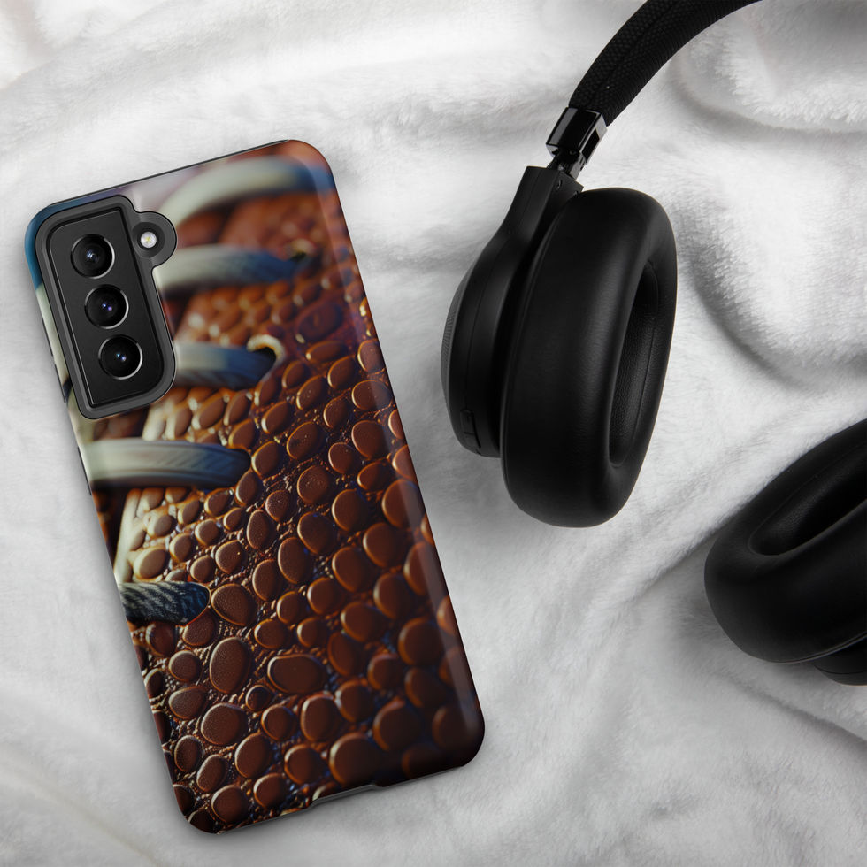 Gridiron Grip Tough case for Samsung Galaxy S21 FE, football laces artwork beside headphones on pale fabric.