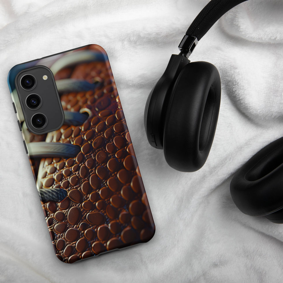 Gridiron Grip Tough case for Samsung Galaxy S23 Plus, football laces artwork beside headphones on pale fabric.