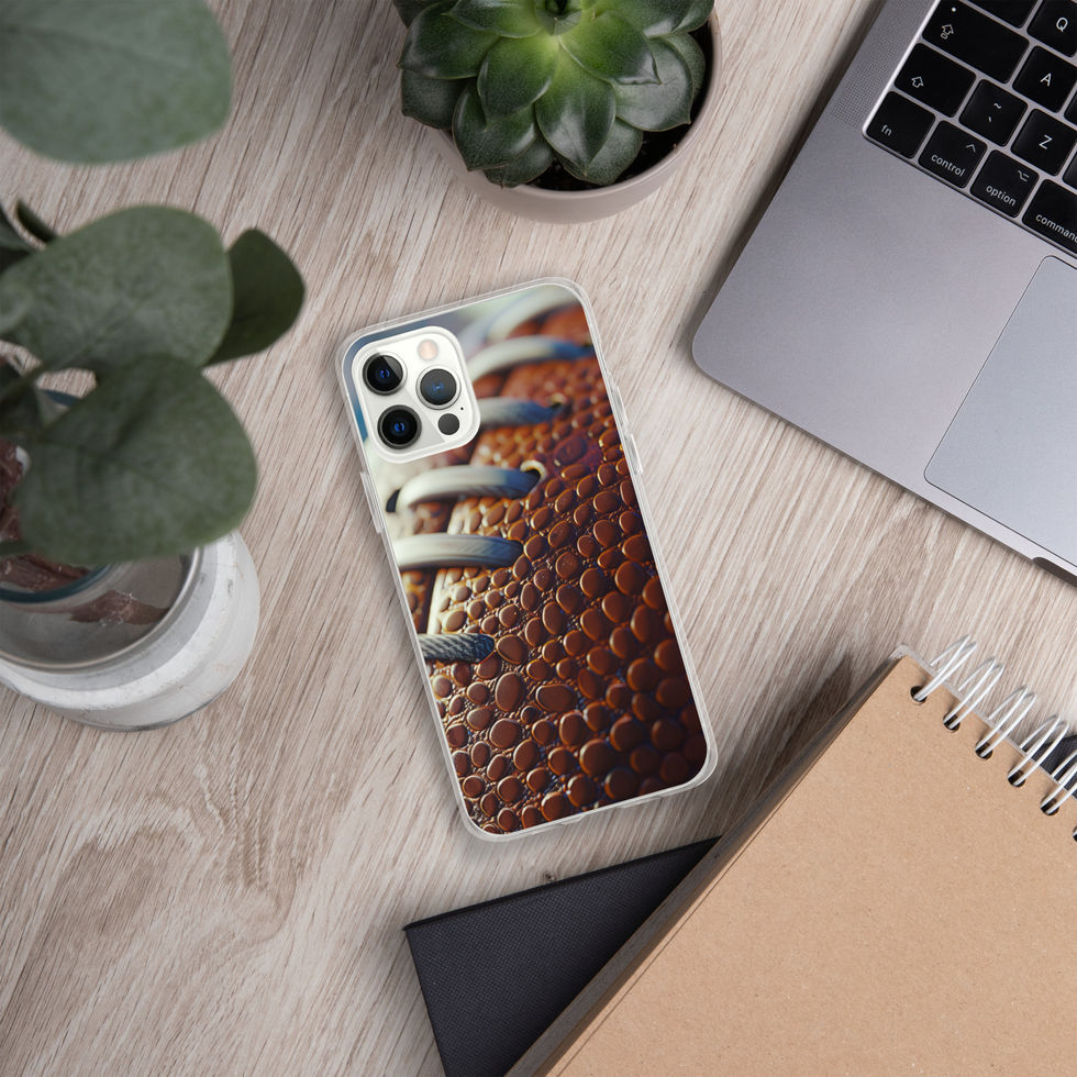 Gridiron Grip clear case for iPhone 12 Pro, football laces print on a light desk beside a laptop and plants.