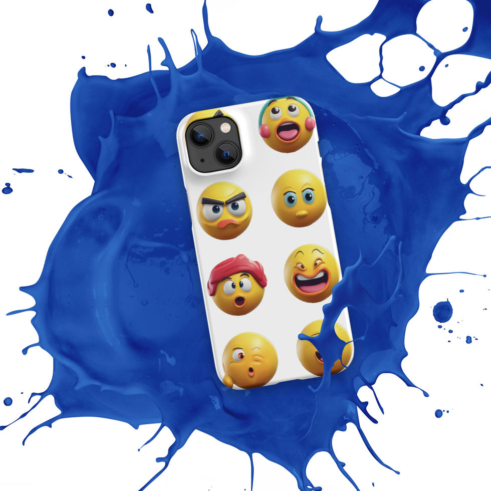 Emoji Frenzy snap iPhone case showing smiling and startled emojis across its printed surface, over a blue paint splash.