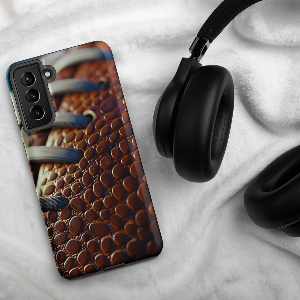 Gridiron Grip Tough case for Samsung Galaxy S21 Plus, football laces artwork beside headphones on pale fabric.