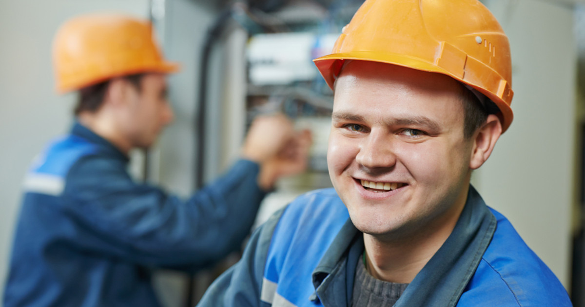 A worker discussing workplace adjustments with an employer while reviewing information about Australian employment rights and support services.