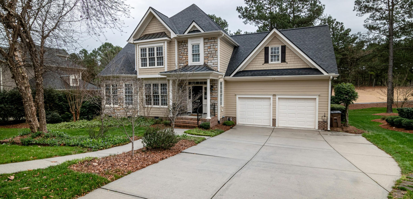Beautiful two-story home with a concrete driveway and attached garage.