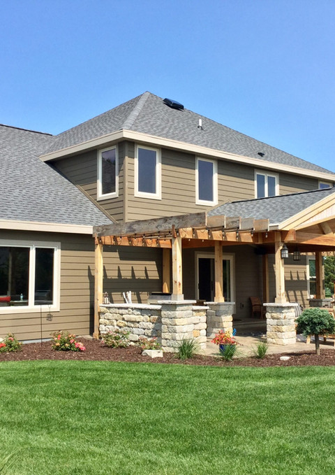 Large house with patio, pergola, and manicured lawn. Quality Over Quantity Everytime.