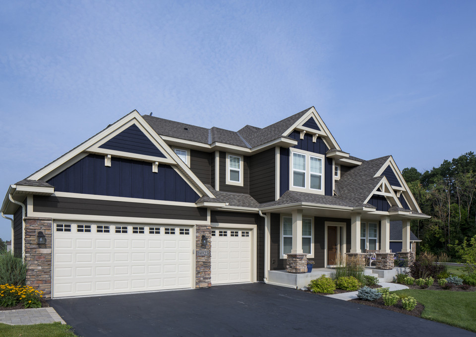 Exterior view of a large two-story house with a blue facade.