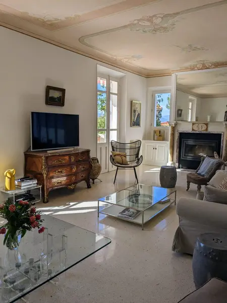 Tastefully decorated living room with french doors opening onto the terrace of the retreat home in the South of France.