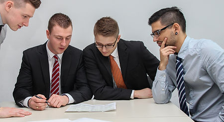 four men looking to the paper on table_edited.jpg