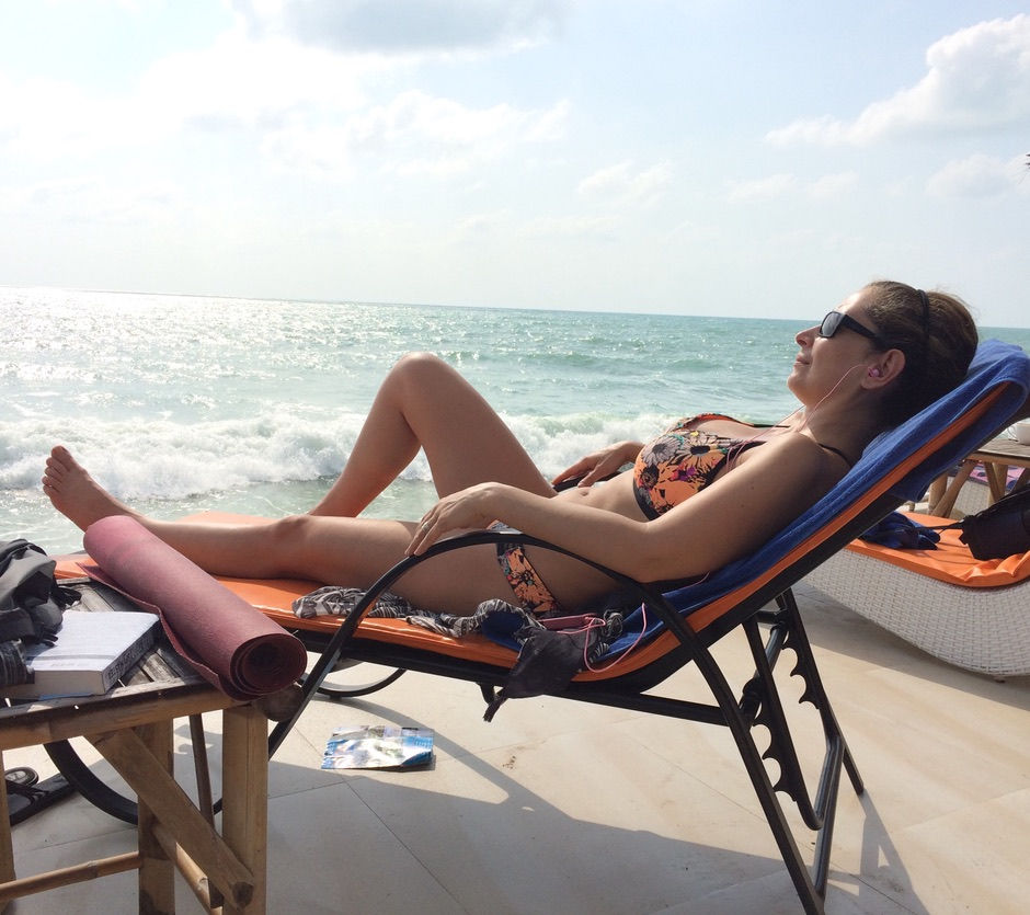 Sanaz in a bikini laying on a beach in Koh Samui