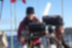 Sanaz steering the sailboat during a calm stretch offshore