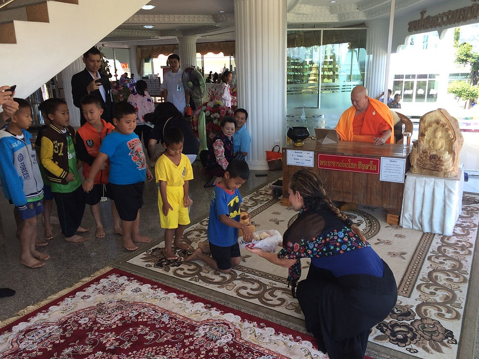 Sanaz giving children gifts at a temple in Chiang Ri.