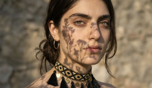 Handcrafted beadwork choker necklace with ornamental design.