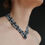 Thumbnail: Side view of Black Beaded Collar Necklace with Geometric Ornament emphasizing its structured fit.