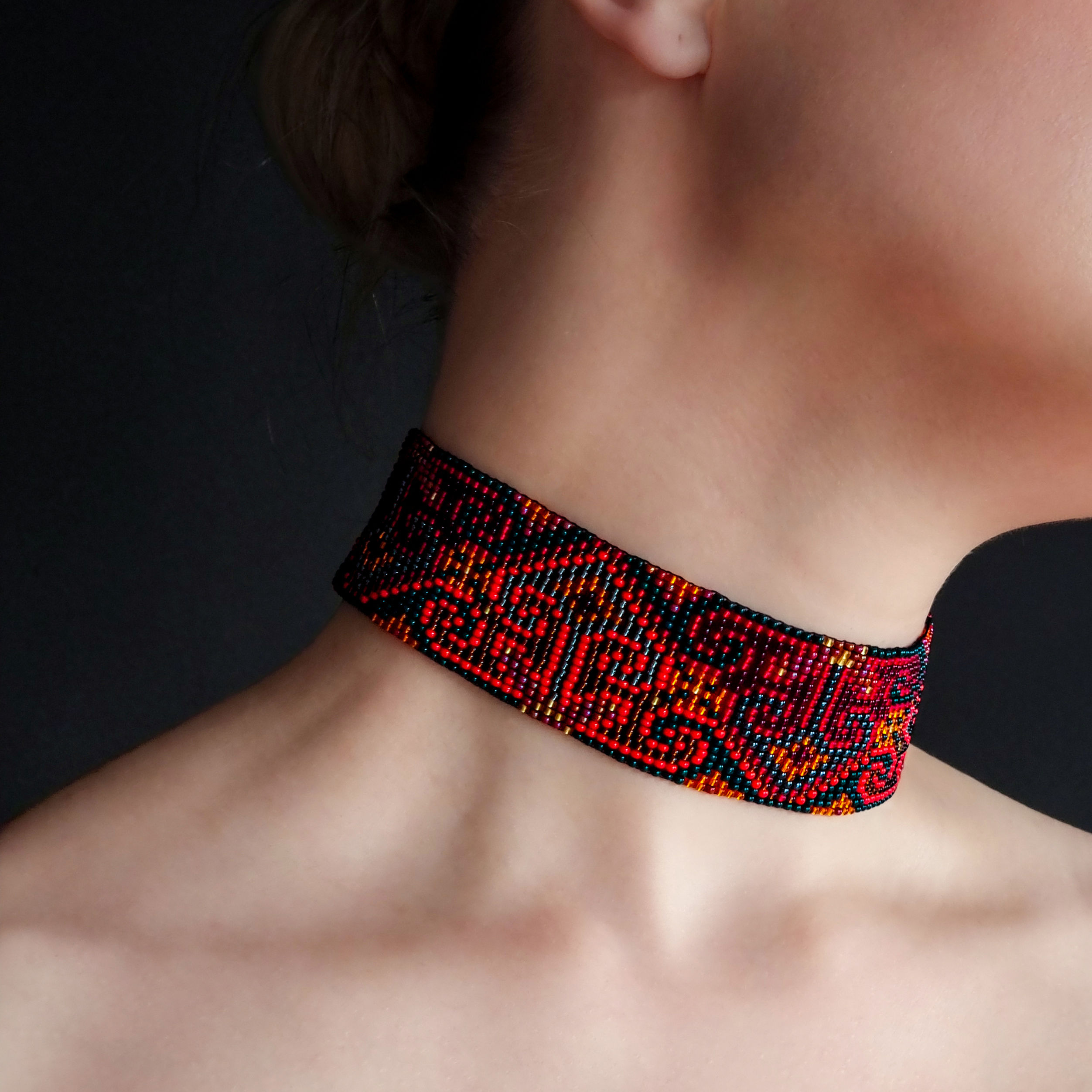 Side view of Red Beaded Choker Necklace with Geometric Ornament emphasizing its elegant fit.