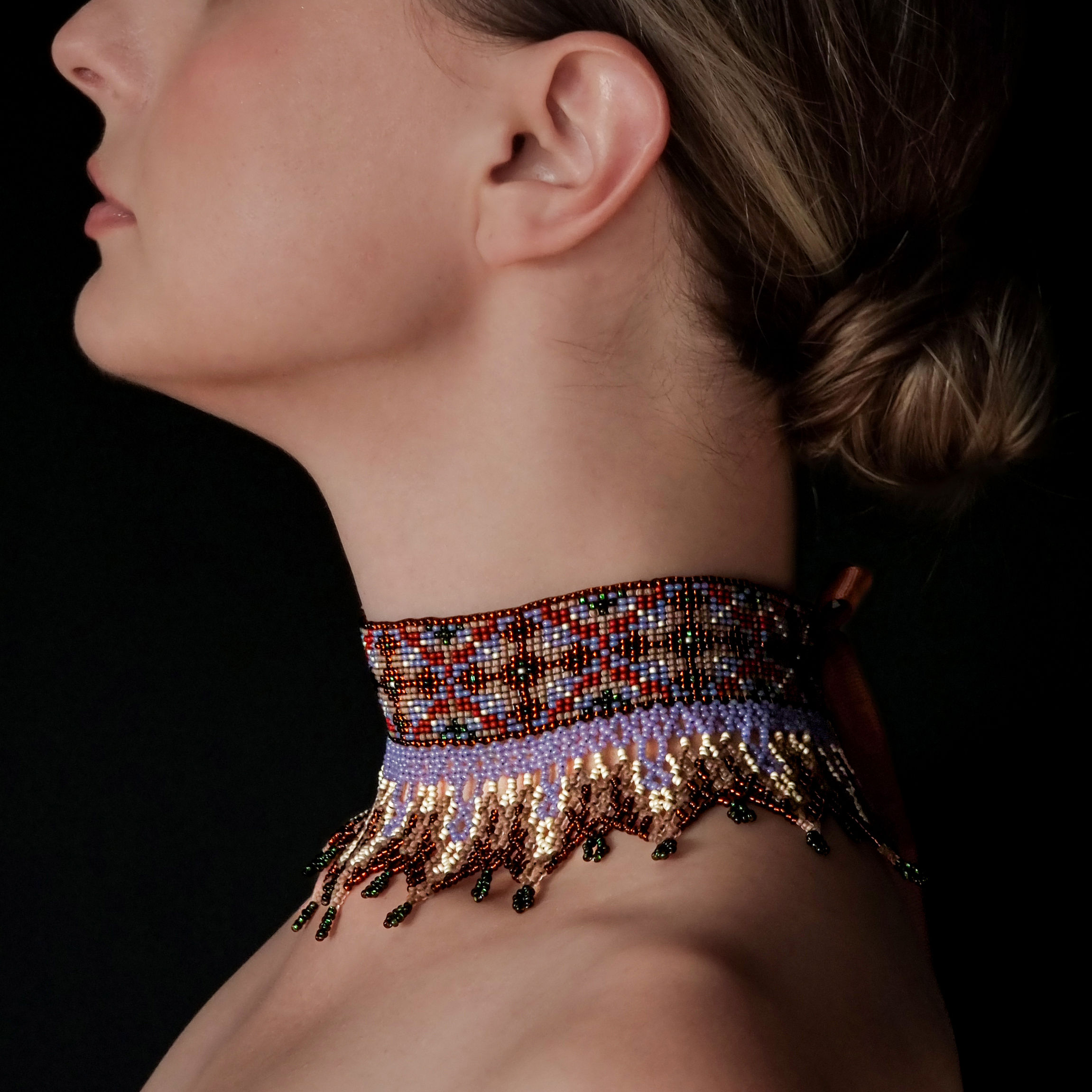 Side view of the Brown Beaded Collar Necklace showing its elegant shape on the neck.