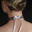 Thumbnail: Back view with ribbon tied in a neat bow, adjustable fit.