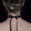 Thumbnail: Back view of the Black Beaded Choker Necklace tied with a ribbon bow.