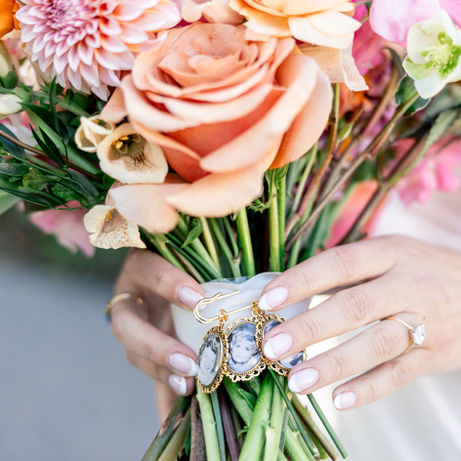 Bride holding Nina and John's wedding bouquet with charms