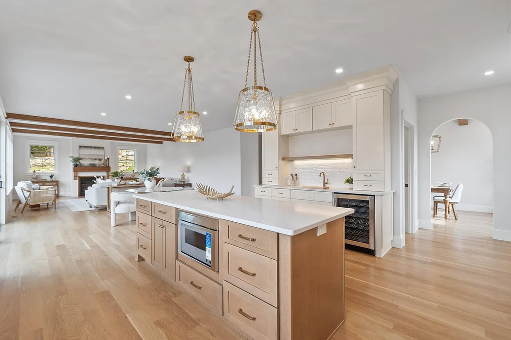 Open concept kitchen with island and adjacent living room
