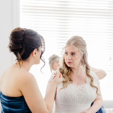 Nefeli in her wedding dress with a bridesmaid in blue.