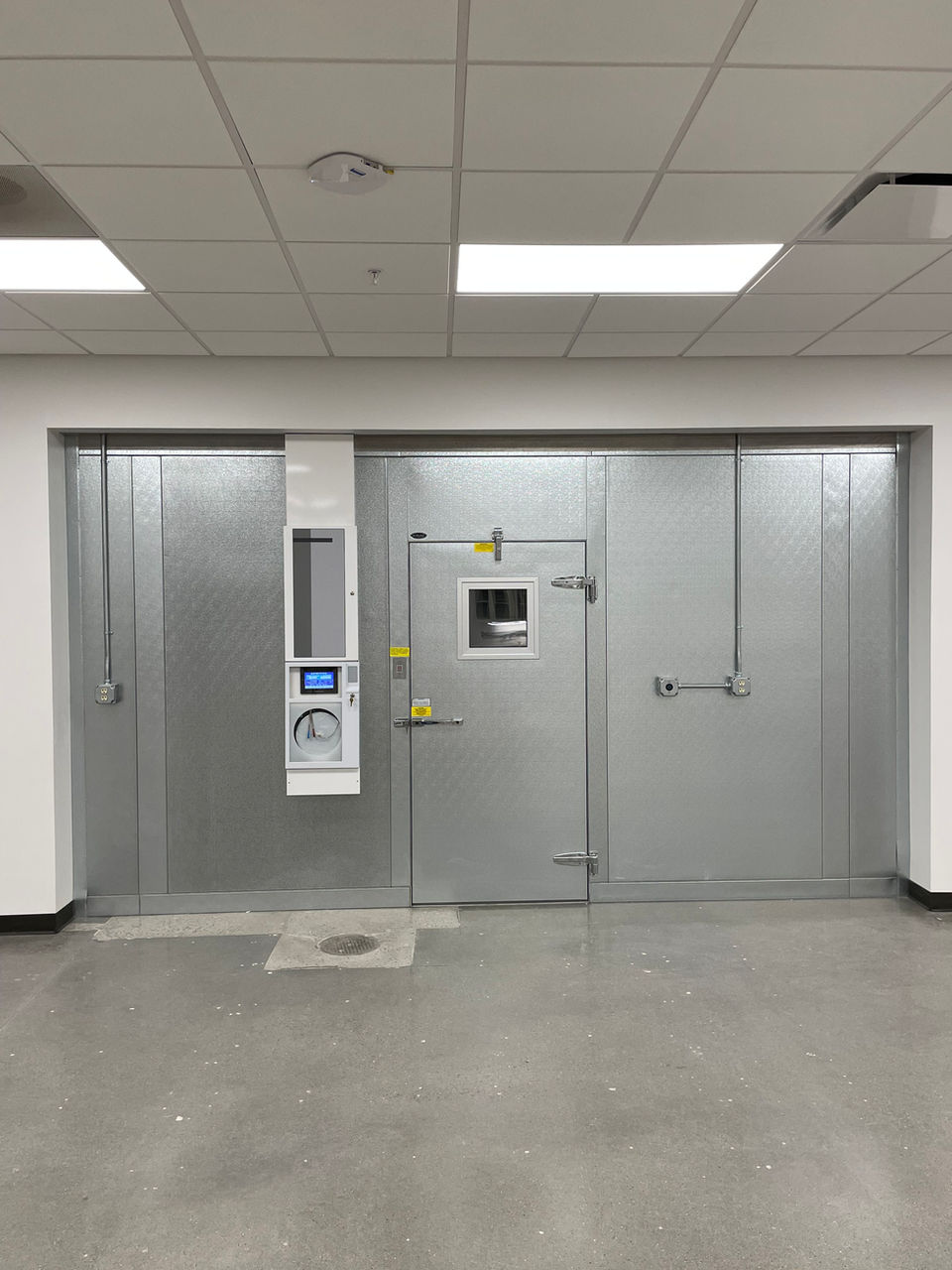 Walk-in freezer with metal door and control panel