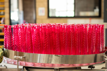 Rows of Excuse Tequila Diamond Edition on a production line