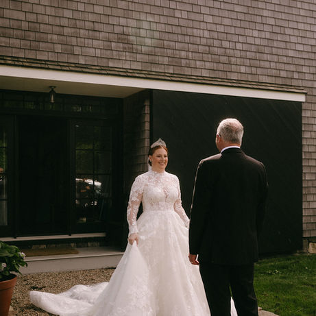 Lauren in her wedding dress smiling at her father.