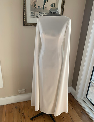 White evening gown with flowy sleeves. The dress is made in ivory crepe fabric. Made to measure, perfectly fitted dress.