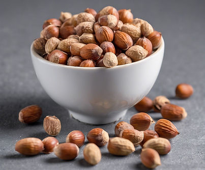 hazel nuts in a bowl with grey backgroun