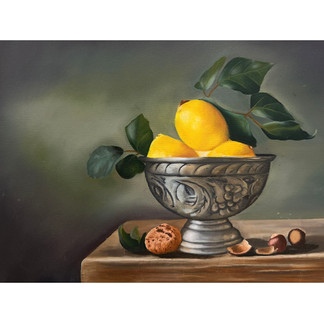 Still life oil painting of a silver ornate bowl holding bright yellow lemons with green leaves, set on a wooden surface with scattered walnut shells.